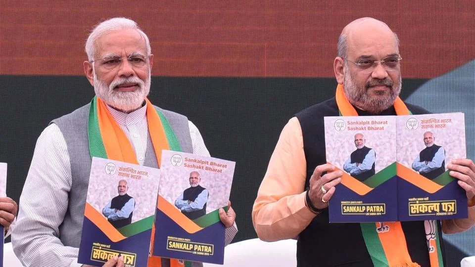 PM Modi and Amir Shah releasing the Sankalp Patra for LS Elections 2019